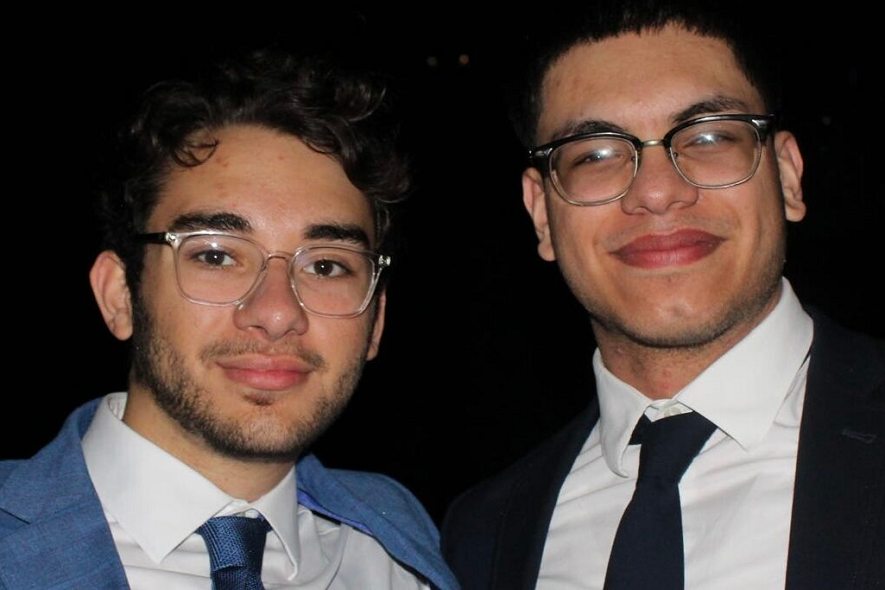 TKE brothers dressed in blue suits at a formal event